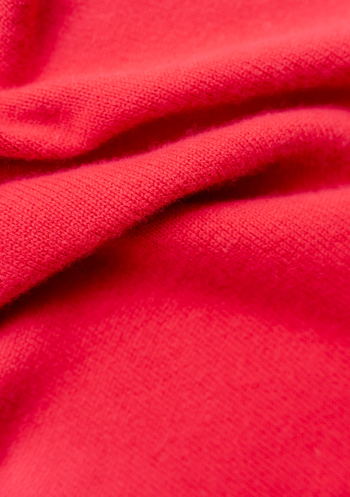 Close-up of soft red fabric texture from TBCo Large Merino Triangle Scarf in Red, knitted from fine merino wool.