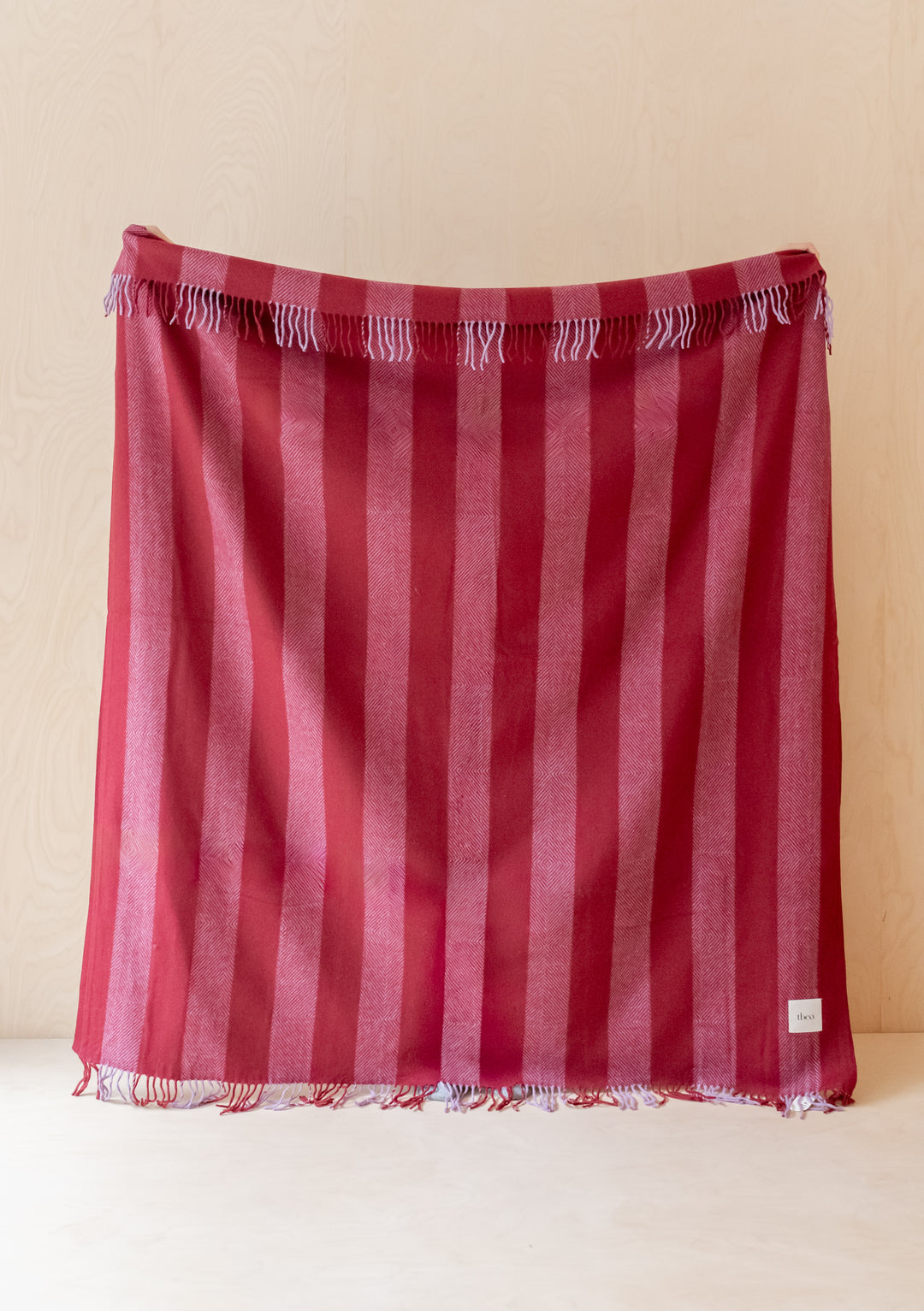 TBCo Sample Sale Recycled Wool Blanket in Lilac Diamond Stripe draped showing soft woven texture and fringed edges
