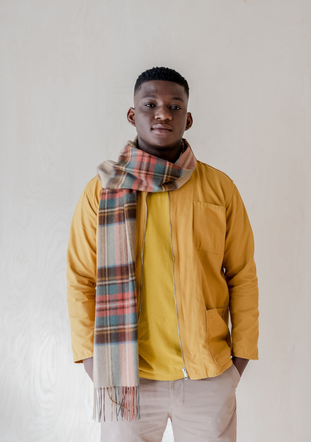 TBCo Mens Lambswool Scarf in Stewart Dress Antique Tartan styled with yellow jacket against neutral background