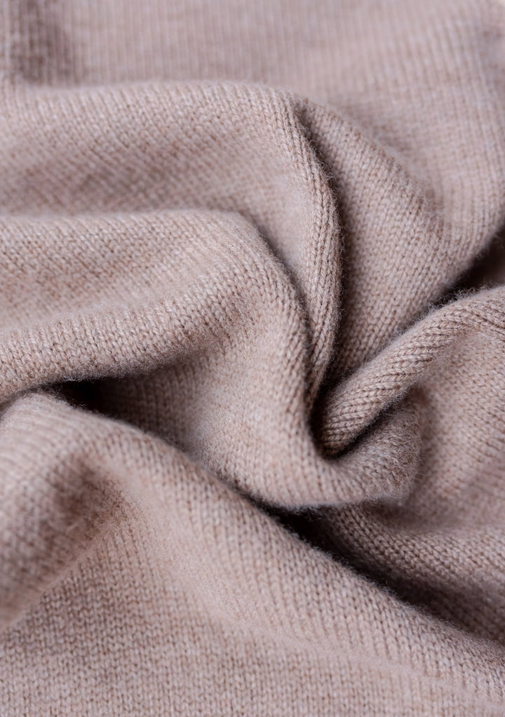 Close-up texture of TBCo Merino Triangle Scarf in Coffee showing soft, knitted wool fabric with gentle folds and draping