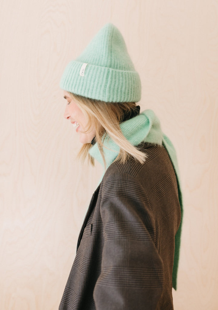 Luxurious TBCo Mohair & Wool Beanie in Mint, ribbed texture winter hat with soft cashmere blend, shown in profile against beige wall