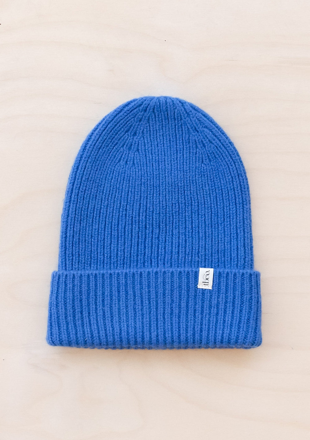TBCo Merino Wool Kids Beanie in bright blue, ribbed knit winter hat with folded brim and small white brand label