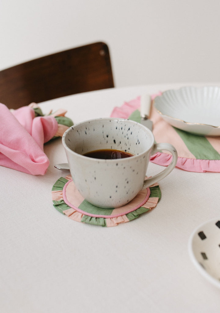 Table setting with TBCo Green Stripe Cotton Coaster and placemats. Sustainable and elegant additions to any table setting, designed for both protection and aesthetic appeal