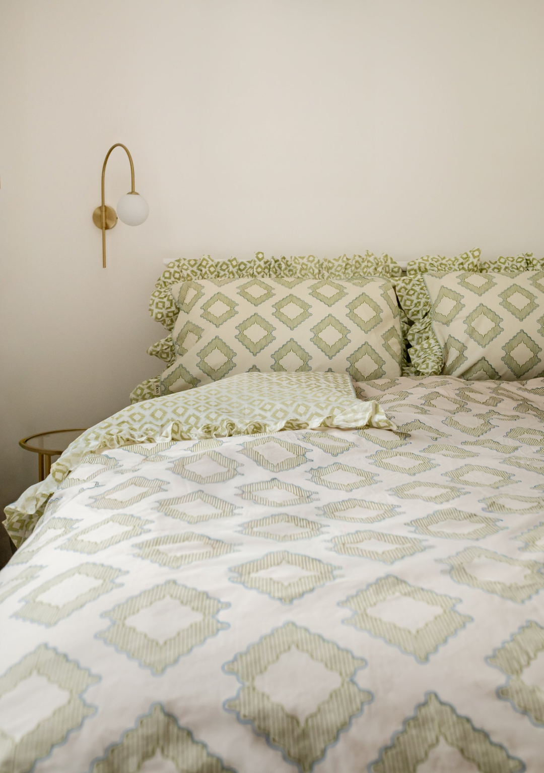 Cotton Duvet Cover & Pillowcases Set in Green Diamond by TBCo featuring ruffled edges and soft geometric pattern on a cream backdrop