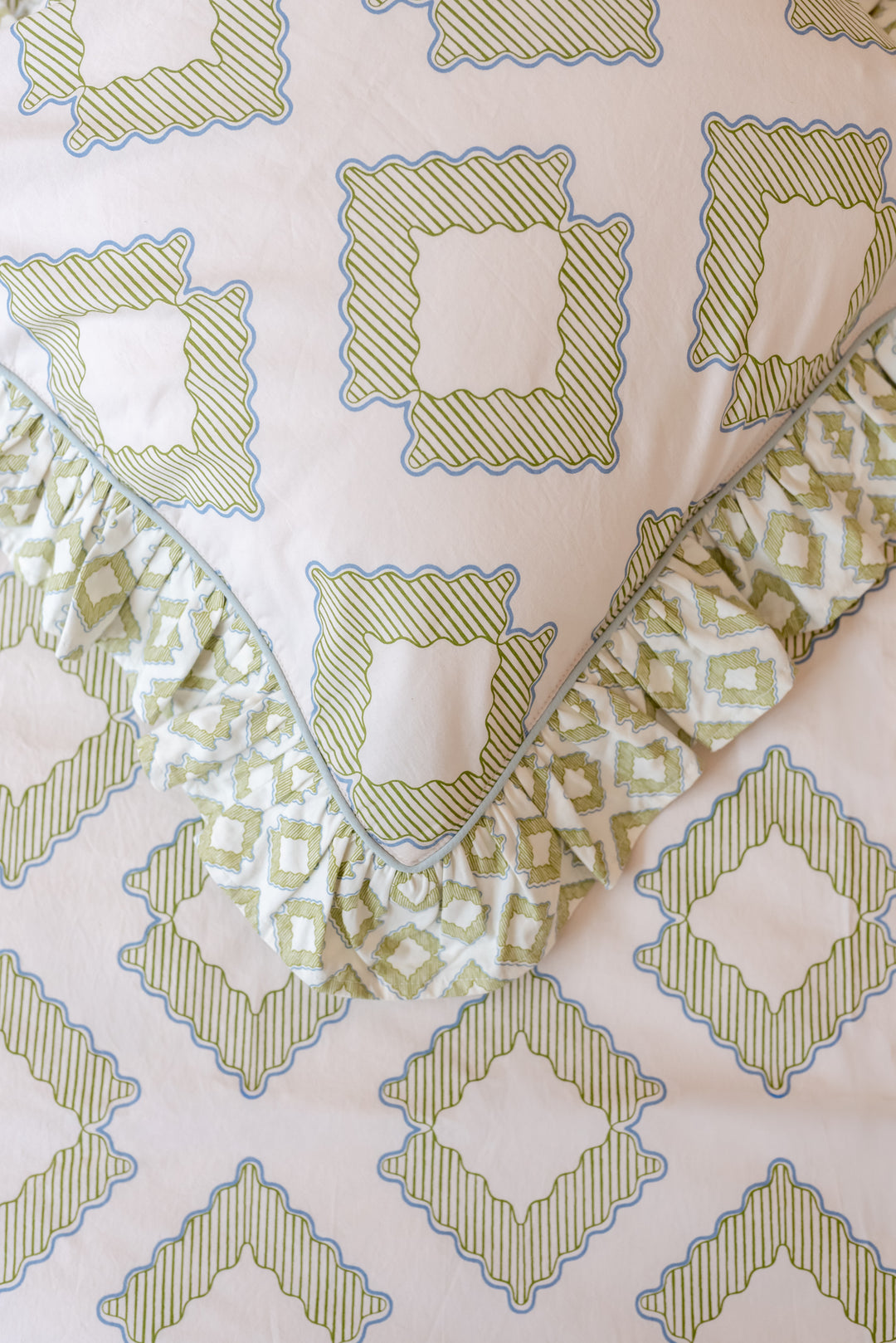 Close-up portrait of TBCo Pair of Cotton Pillowcases in Green Diamond showing ruffled edges and diamond pattern.