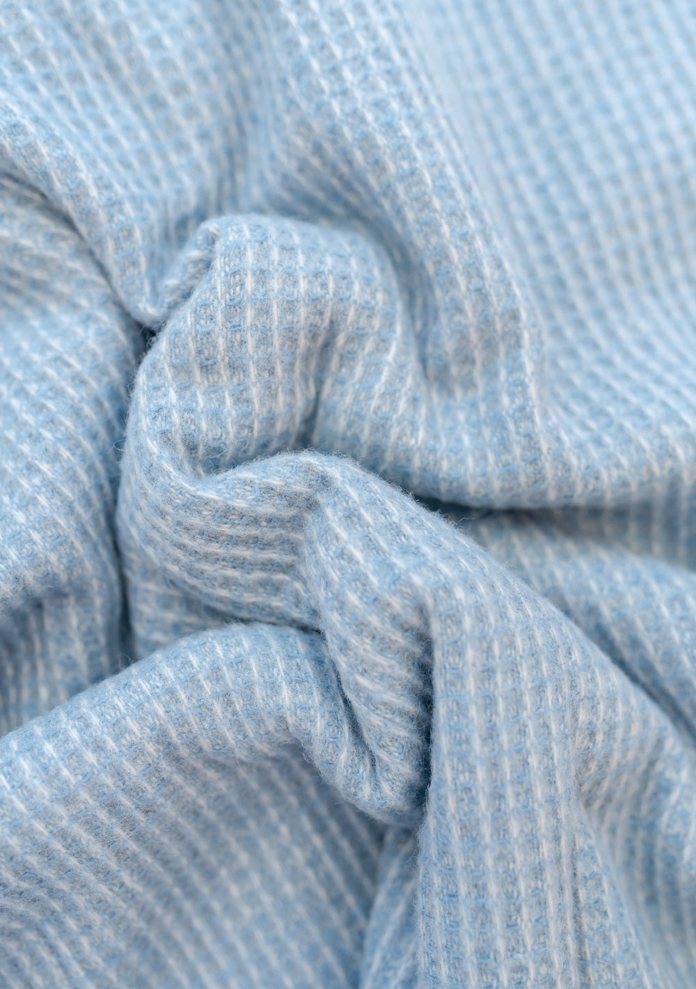 Close-up texture detail of TBCo Recycled Wool Blanket in Azure Waffle showing soft woven waffle weave pattern