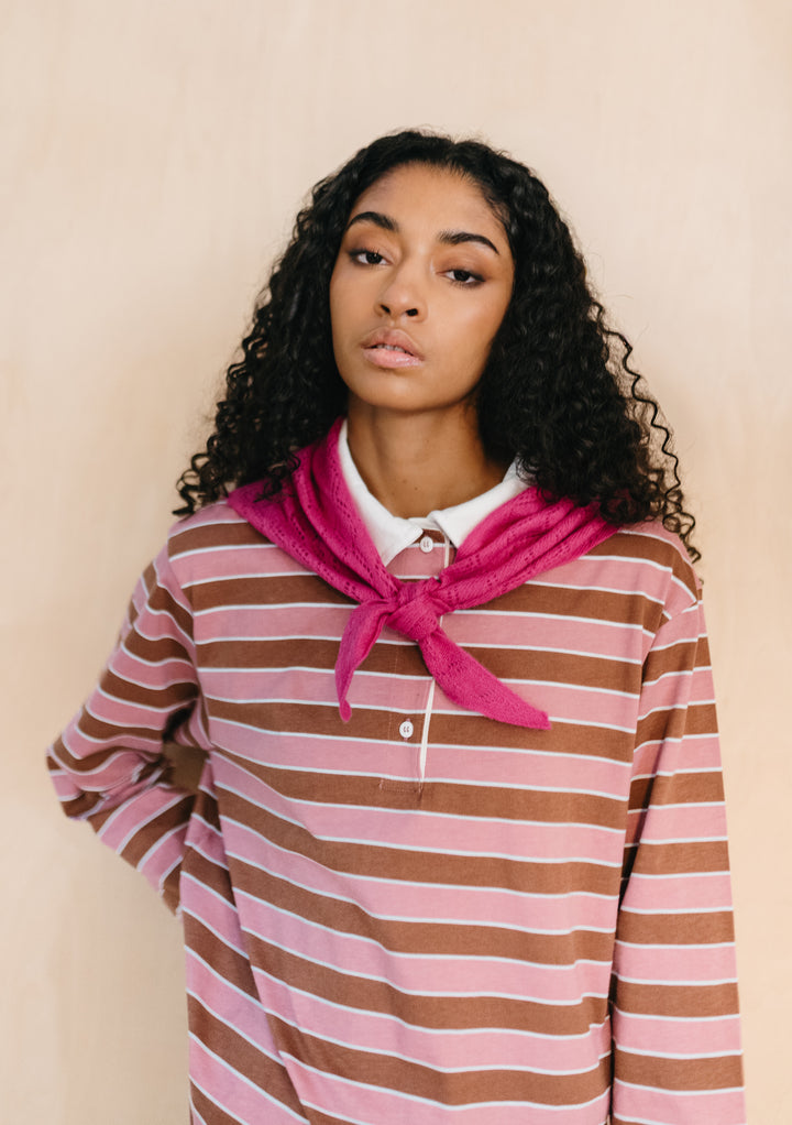 Model wearing TBCo Merino Wool Triangle Scarf in Magenta Pointelle tied at neck with textured knit pattern visible