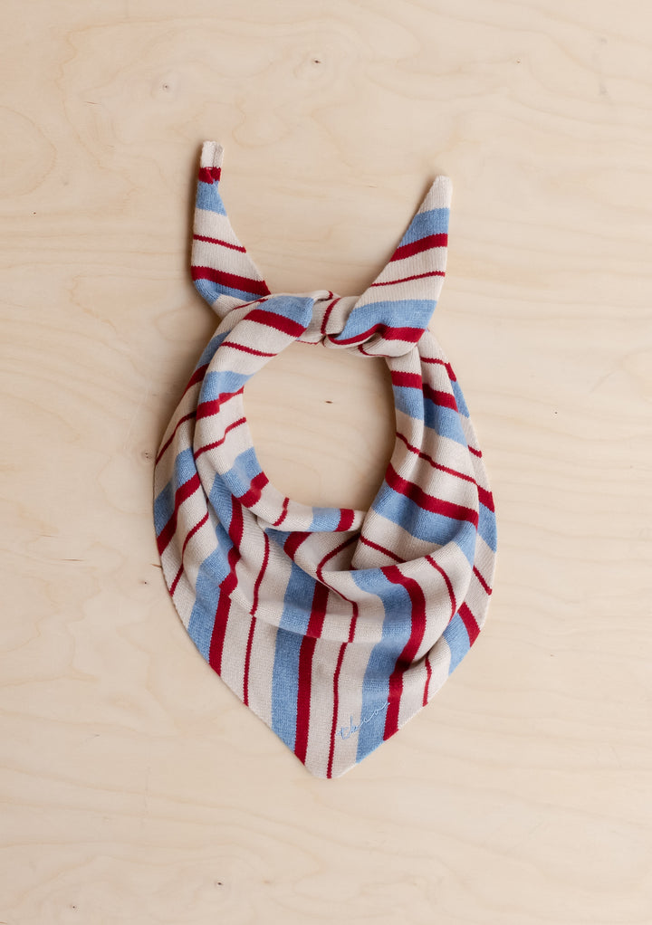 TBCo Merino Wool Triangle Scarf in Blue & Red Stripe with irregular stripes tied on light wood background