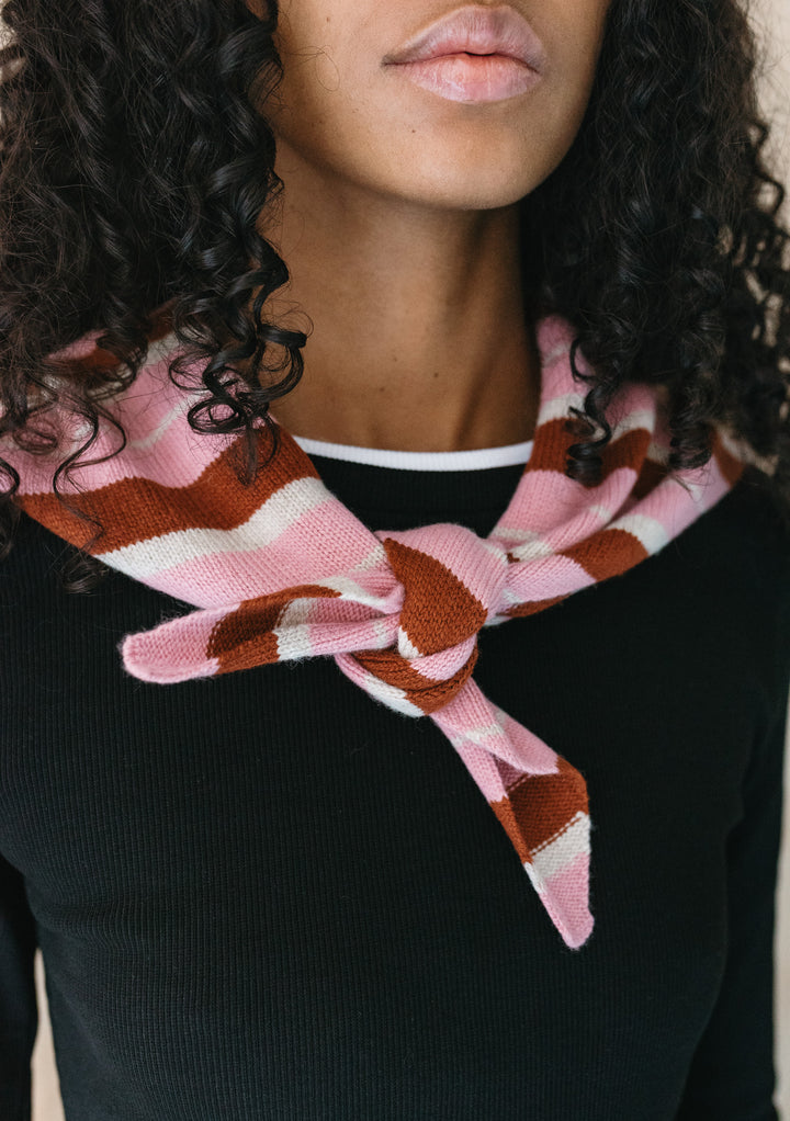 TBCo Merino Wool Triangle Scarf in Pink & Rust Stripe knotted around neck on model wearing black top