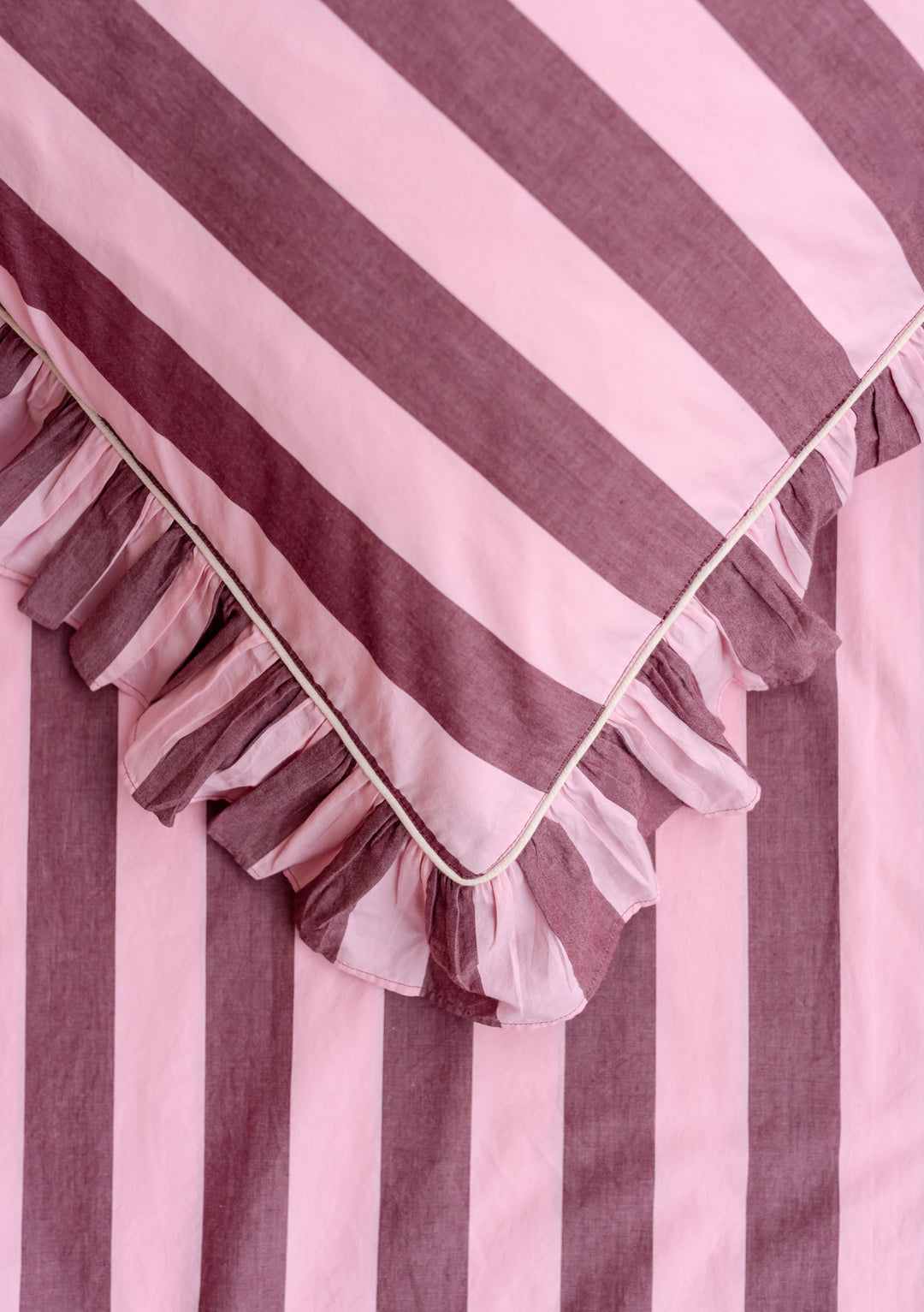 Close-up of ruffled edge detail on TBCo Pair of Cotton Pillowcases in Pink & Burgundy Stripe with soft poplin cotton fabric