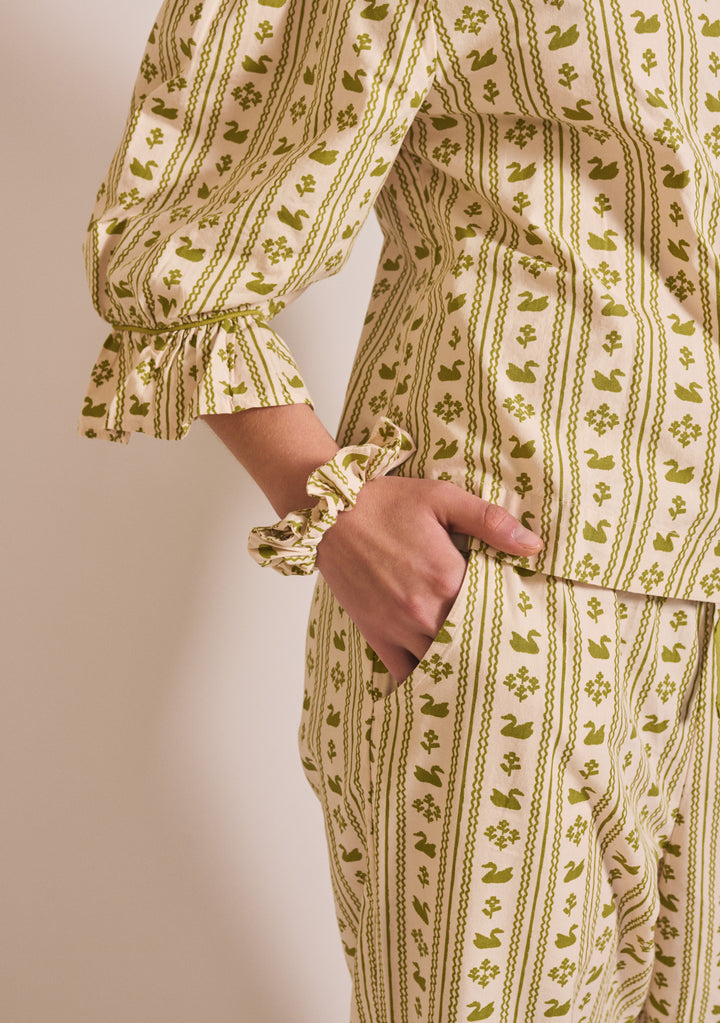 Close-up of TBCo Cropped Cotton Pyjamas in Olive Swan with gathered cuff and matching scrunchie on soft cotton fabric