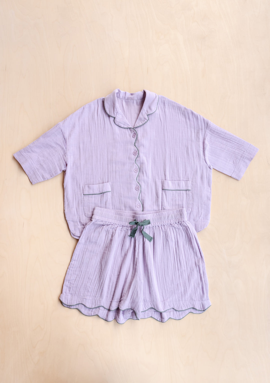 Cotton Pyjamas in Lilac by TBCo laid flat showing soft fabric and green trimmed drawstring in gallery position 5 portrait view