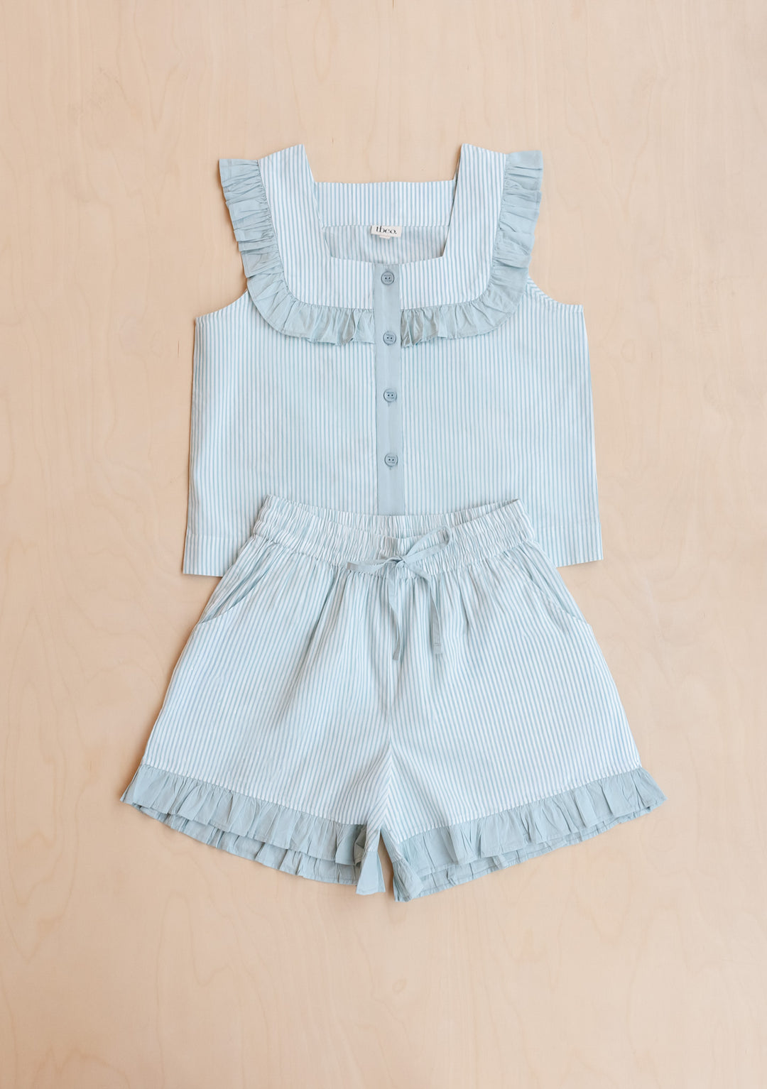 Portrait image gallery position 7 showing TBCo Cotton Pyjamas in Blue Stripe Ruffle with sleeveless top and ruffle shorts