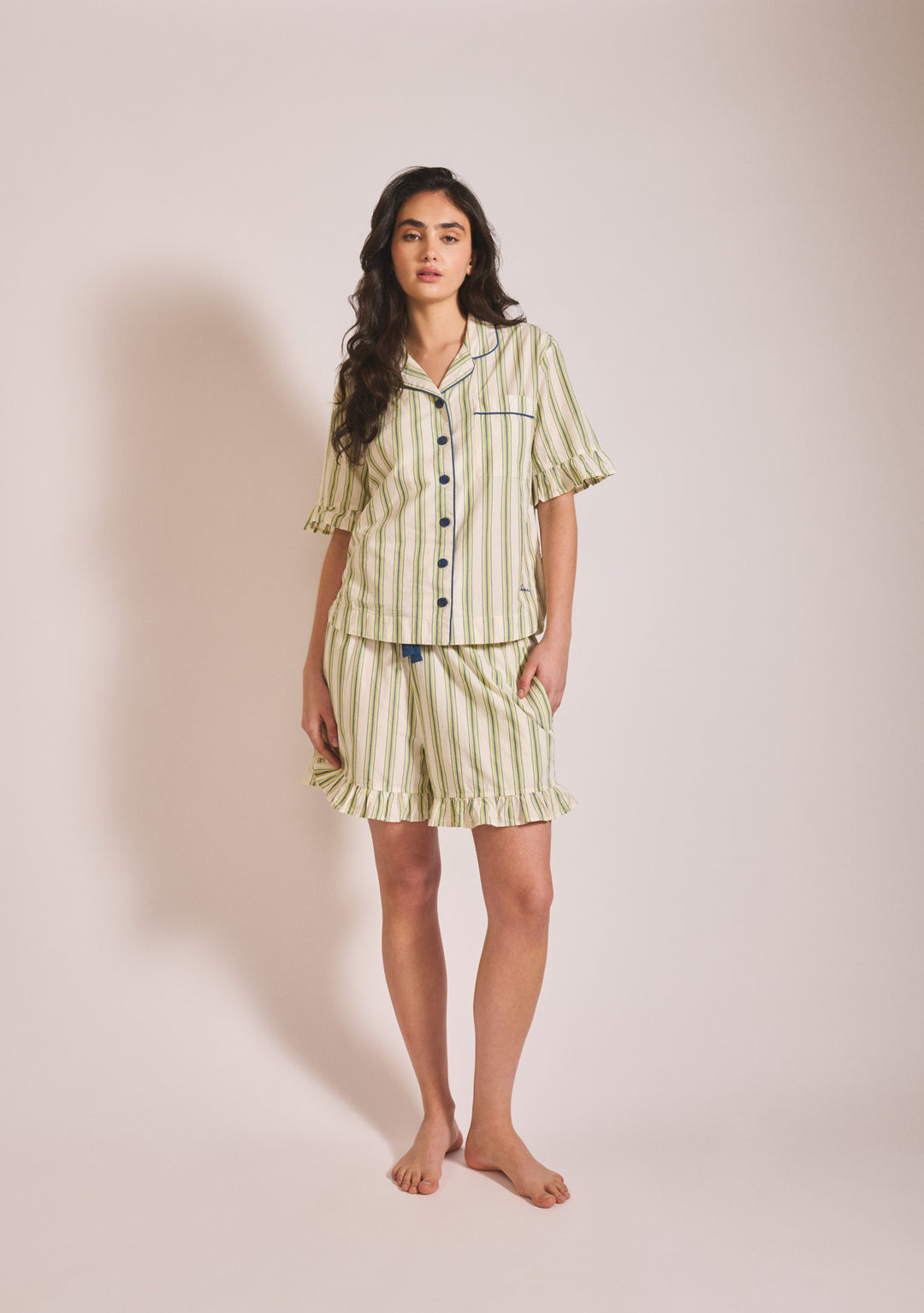 Model wearing TBCo Cotton Pyjamas in Olive Stripe Ruffle in portrait gallery position one with breathable cotton shorts set