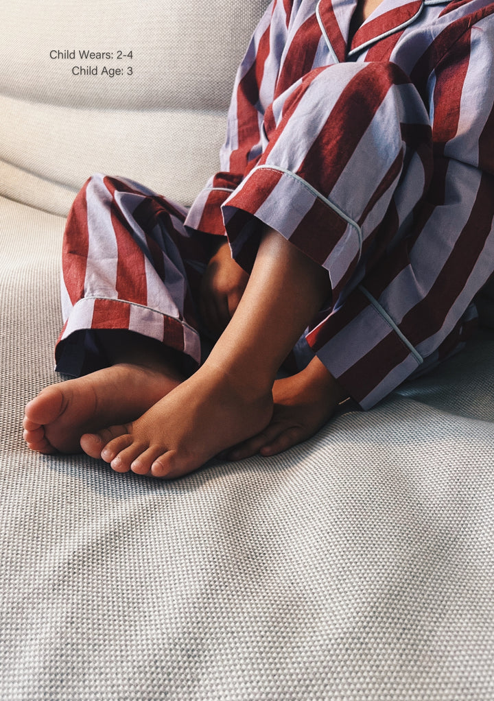 Cotton Kids Pyjamas in Lilac Stripe by TBCo, showing child’s feet and relaxed fit cosy cotton pyjamas.