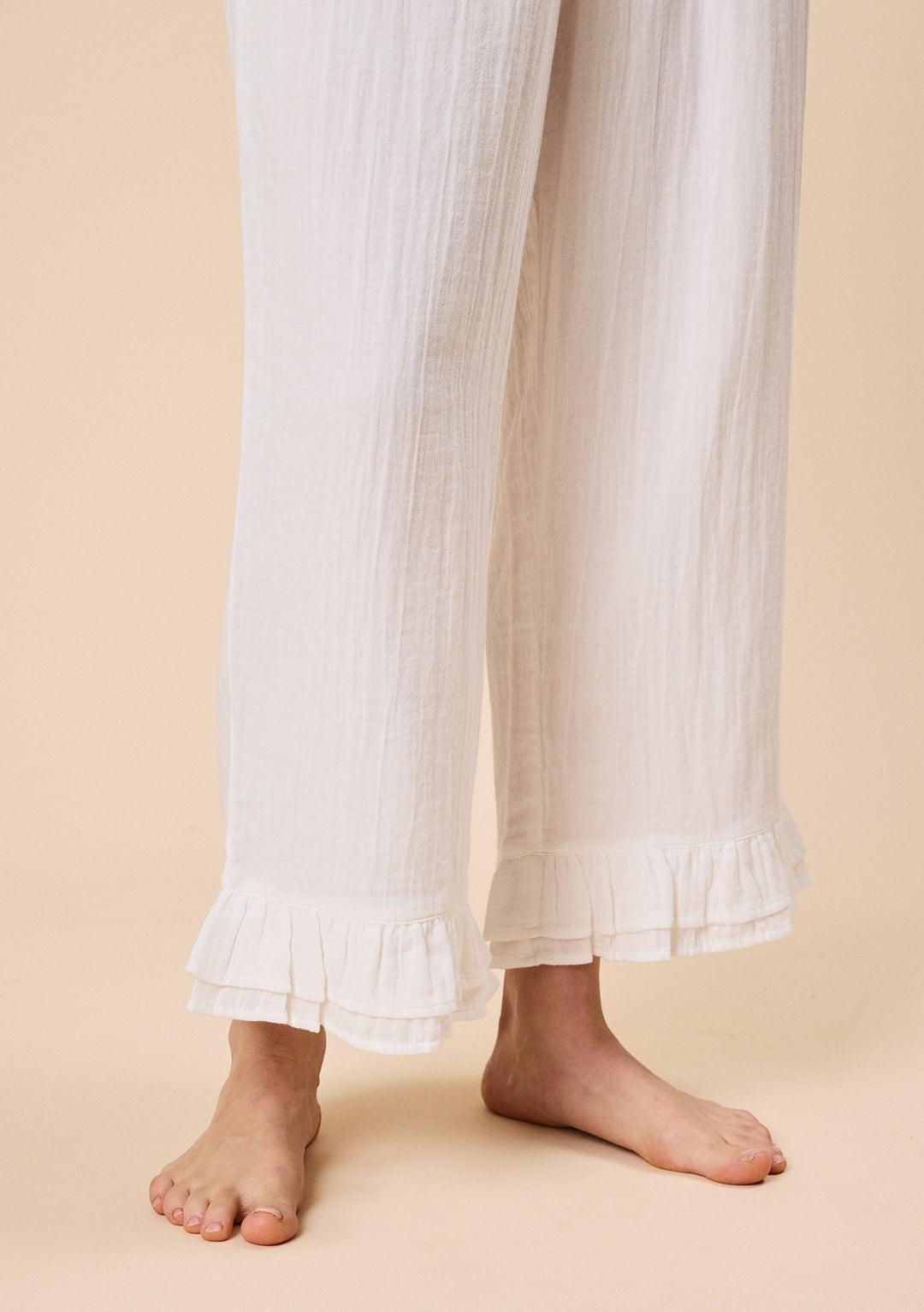 Close-up of TBCo Ankle Grazer Cotton Pyjamas in White Ruffle with breathable natural & recycled fibres, Certified B-Corp, women-founded, designed to make an impact