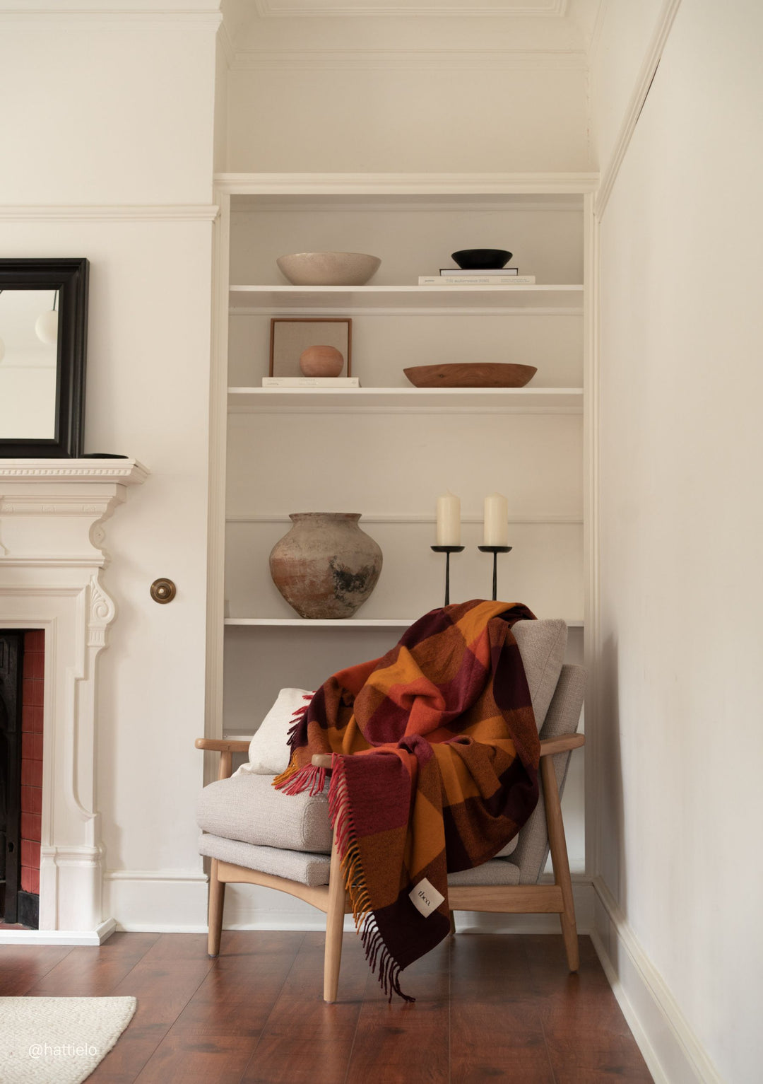 Recycled Wool Blanket in Ochre Bold Check draped on chair showcasing TBCo’s warm plaid design and soft fringed edges