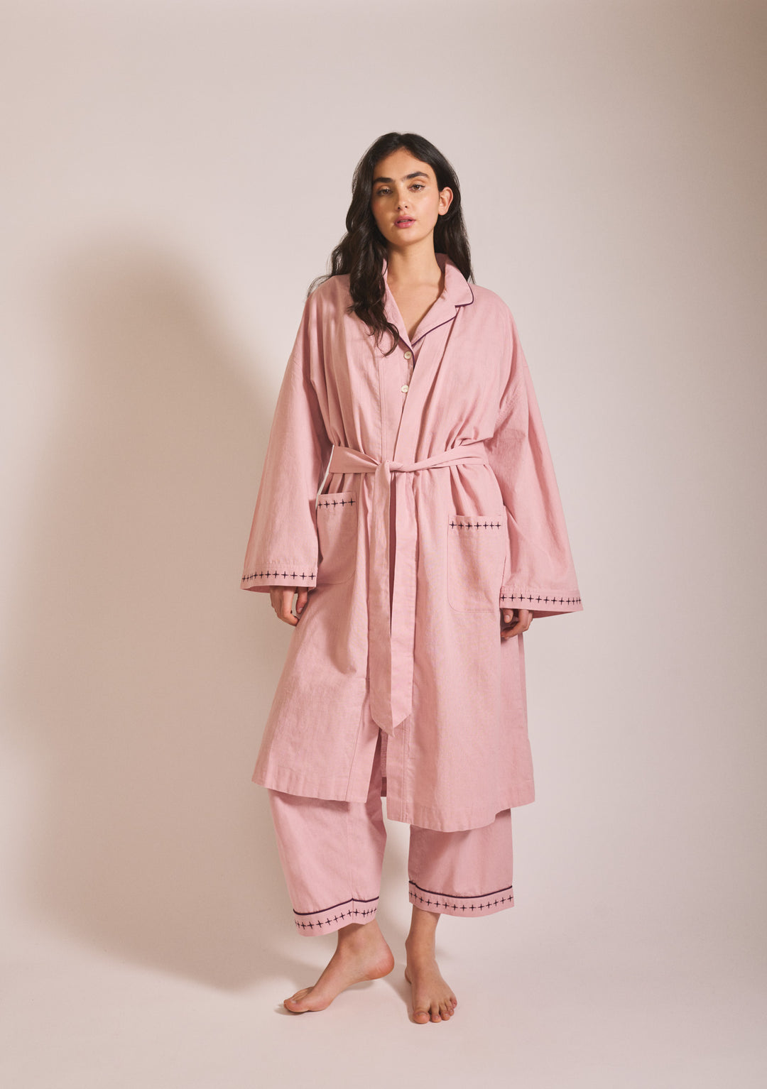 Woman in portrait wearing TBCo Cotton & Linen Robe in Pink with blackberry embroidery, gallery position one, 1442x2048px