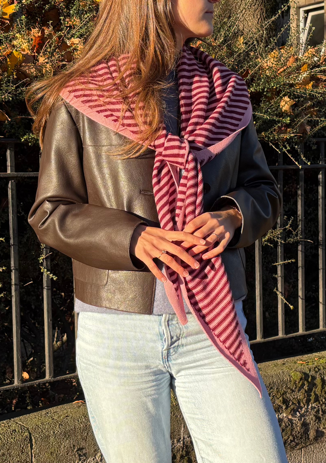 Large Merino Triangle Scarf in Pink Stripe by TBCo styled with knot, soft merino wool and embroidered logo visible