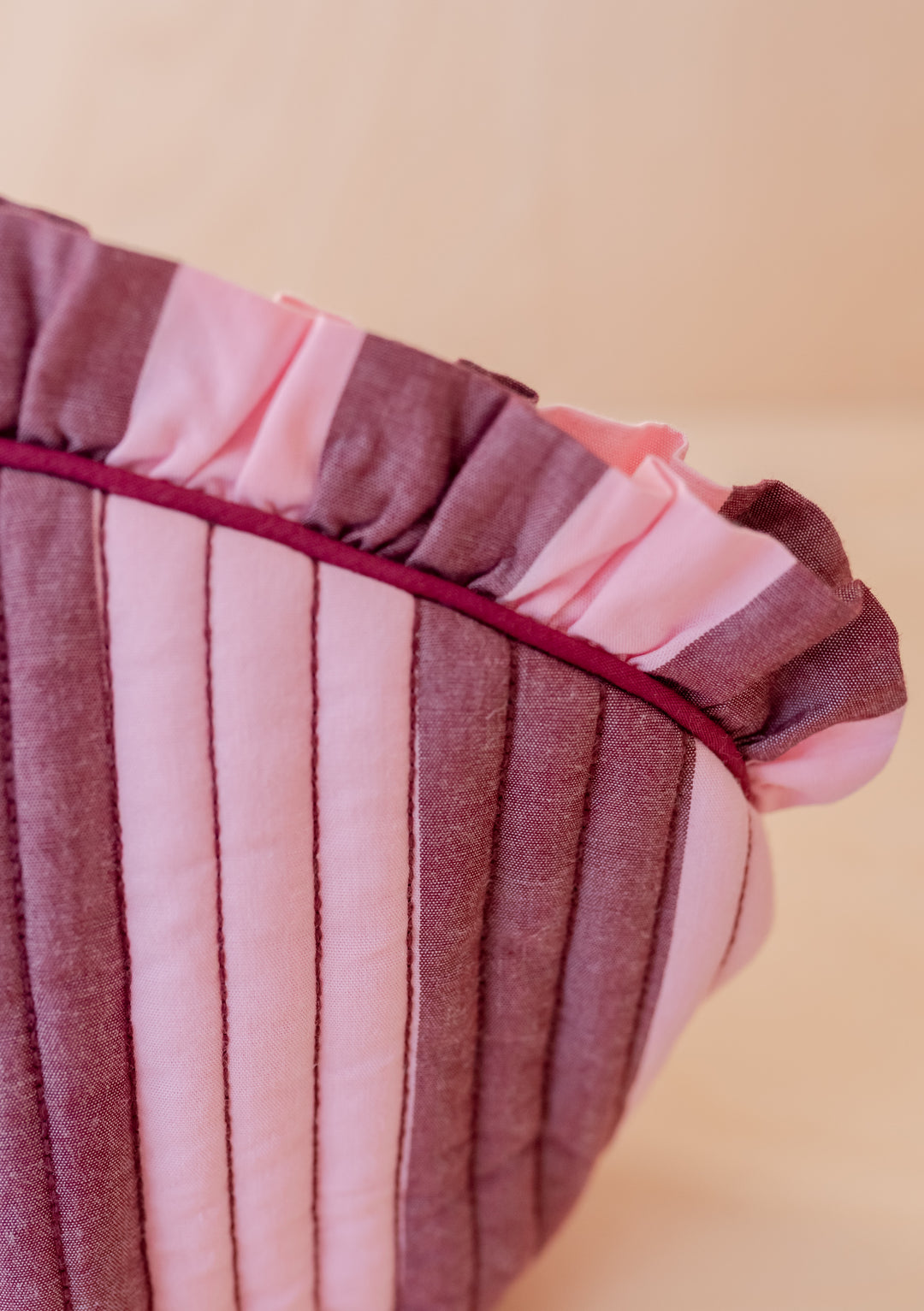 Close-up of ruffled edge and striped cotton fabric detail on TBCo Cotton Wash Bag in Pink & Burgundy Stripe