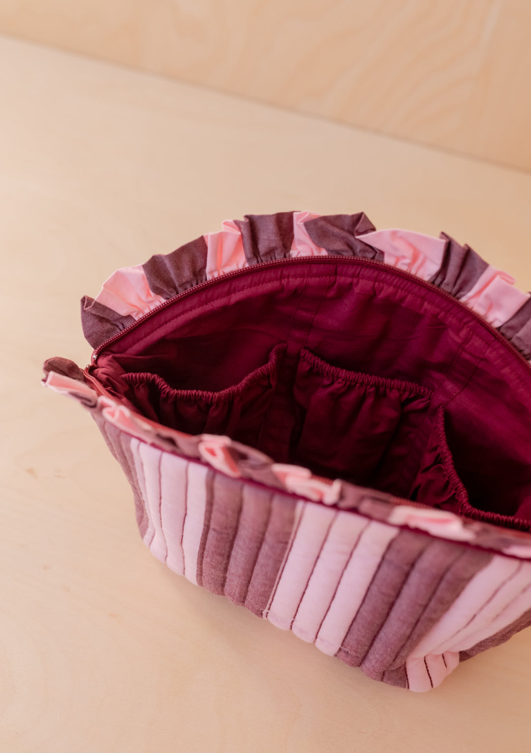 Open Cotton Wash Bag in Pink & Burgundy Stripe by TBCo showing ruffled top and interior elasticated pockets