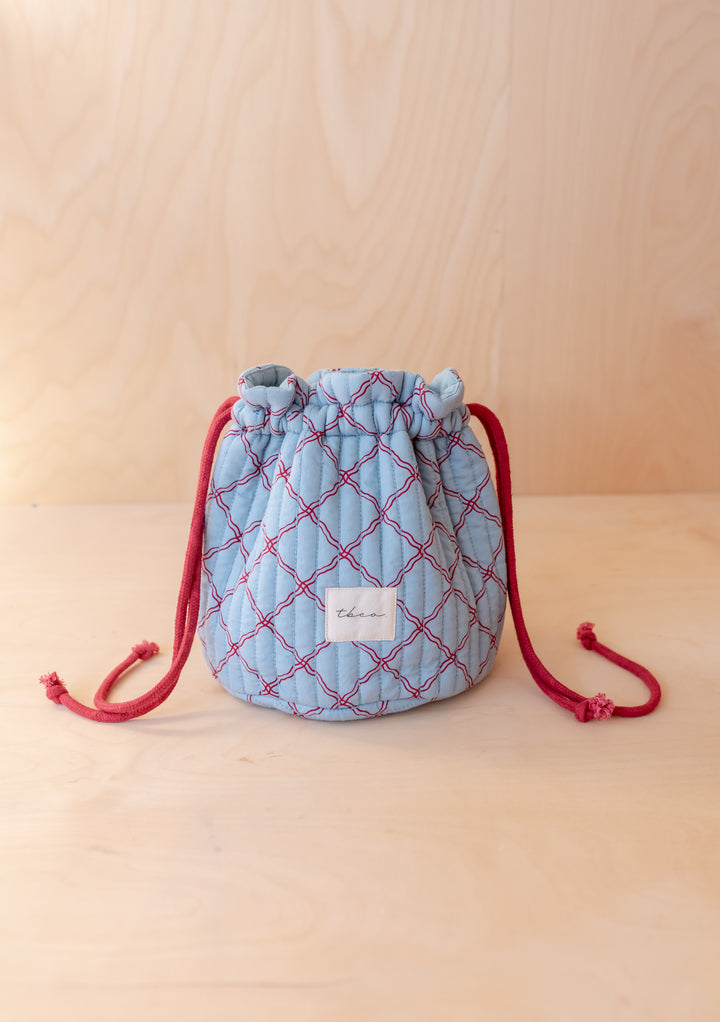 Cotton Wash Bag in Blue Lattice by TBCo with red lattice pattern and drawstring, gallery position 1 portrait shot